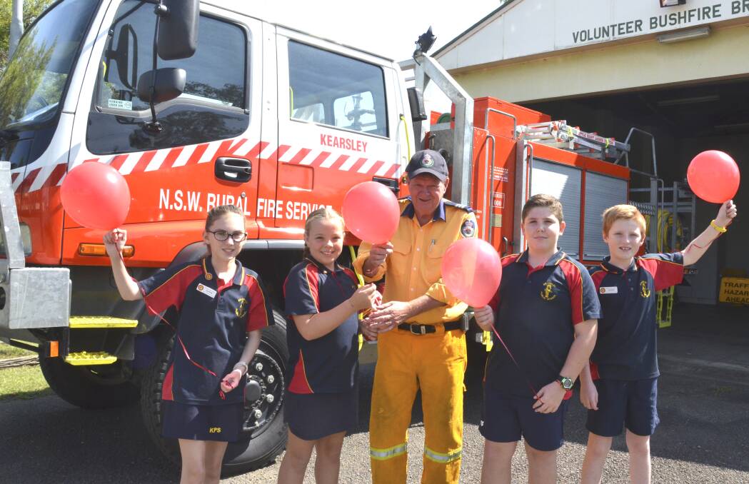 RED-LETTER DAY: Kearsley Public School leaders Aryahn Harrison and Annabelle Rockley, Kearsley Rural Fire Brigade captain Les Goldie, and school leaders Korey Thomas and Harrison Reed are looking forward to National Red Balloon Day on February 28. Picture: Krystal Sellars
