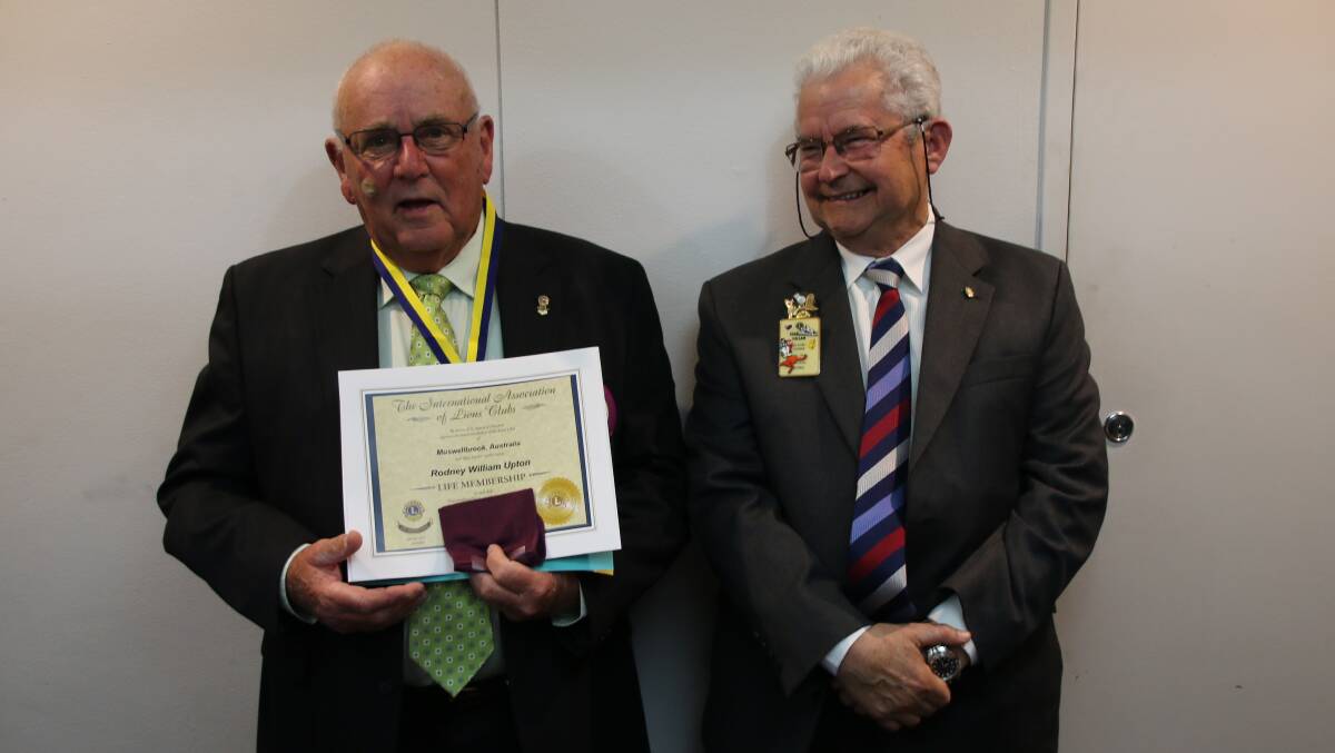 Rod Upton is presented with Life Membership of Muswellbrook Lions by Past District Governor Ken Hallam.