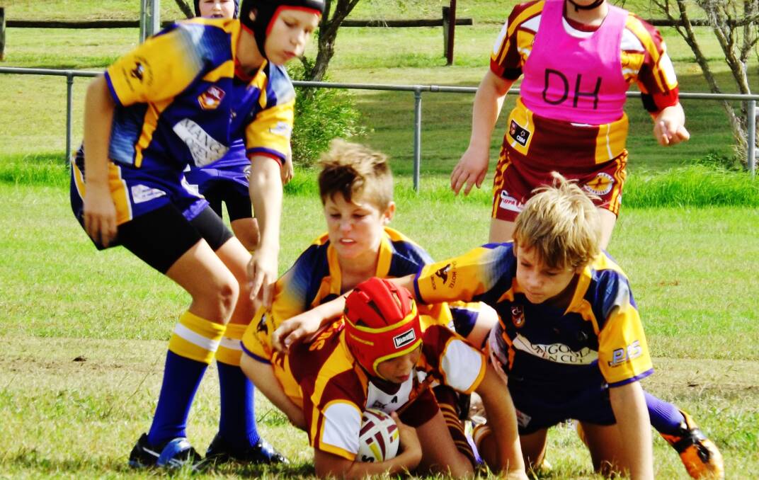 TRIPLE THREAT: Muswellbrook Rams' under-12 players Kobi Anderson, Caleb Smith and Kayne Hoad team up to stop a rival in his tracks.