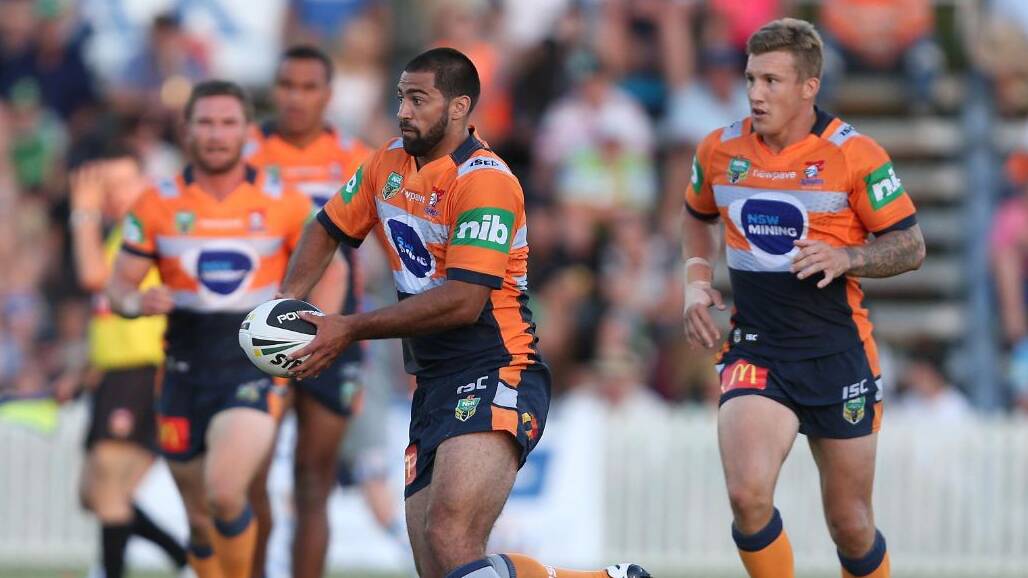ON THE BALL: David Bhana in the hi-vis mining kit as he runs the ball for the Newcastle Knights.