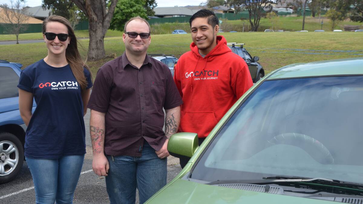 TRAINING: Resident Brian Stocks (centre) with driver relations manager Varya Foreman and Brandon Winterstein from GoCatch in Muswellbrook on Wednesday.