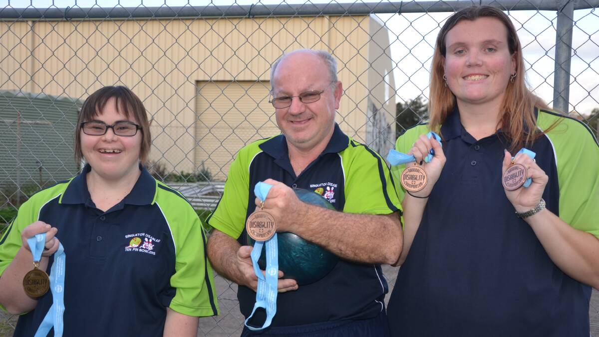 SUCCESS: Ten pin bowlers Erin Constable, Garth Hutchison and Jennifer McMahon proudly show off their medals from the 29th National Disability Championships.