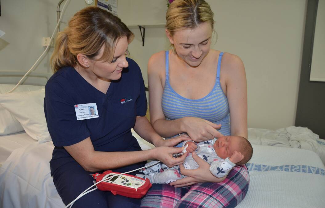 DONATION: Registered midwife Emma (Harrison) Domina demonstrates the new RAD-5 Pulse Oximeter donated to Muswellbrook Hospital with newborn Myla Mae Smith and her mum, Alex Stevenson.