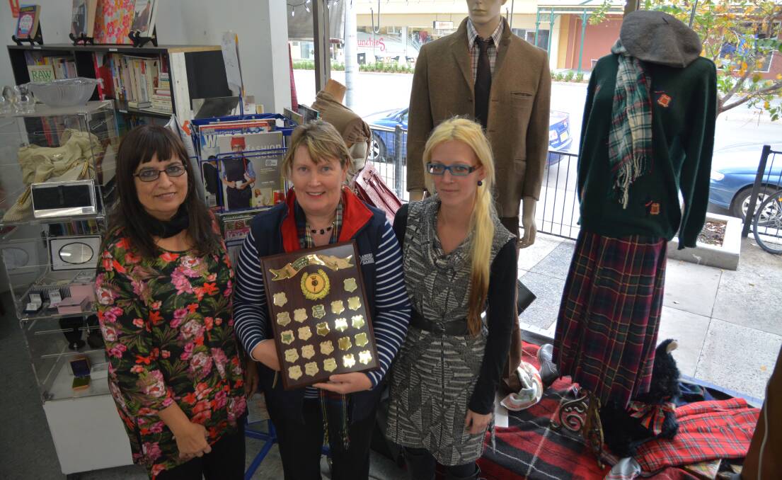 WELL DONE: Muswellbrook Lifeline's Valencia Cuttriss, Aberdeen Highland Games committee member Elizabeth Birch, and Muswellbrook Lifeline's Tammy Tomkins with part of their winning window display.