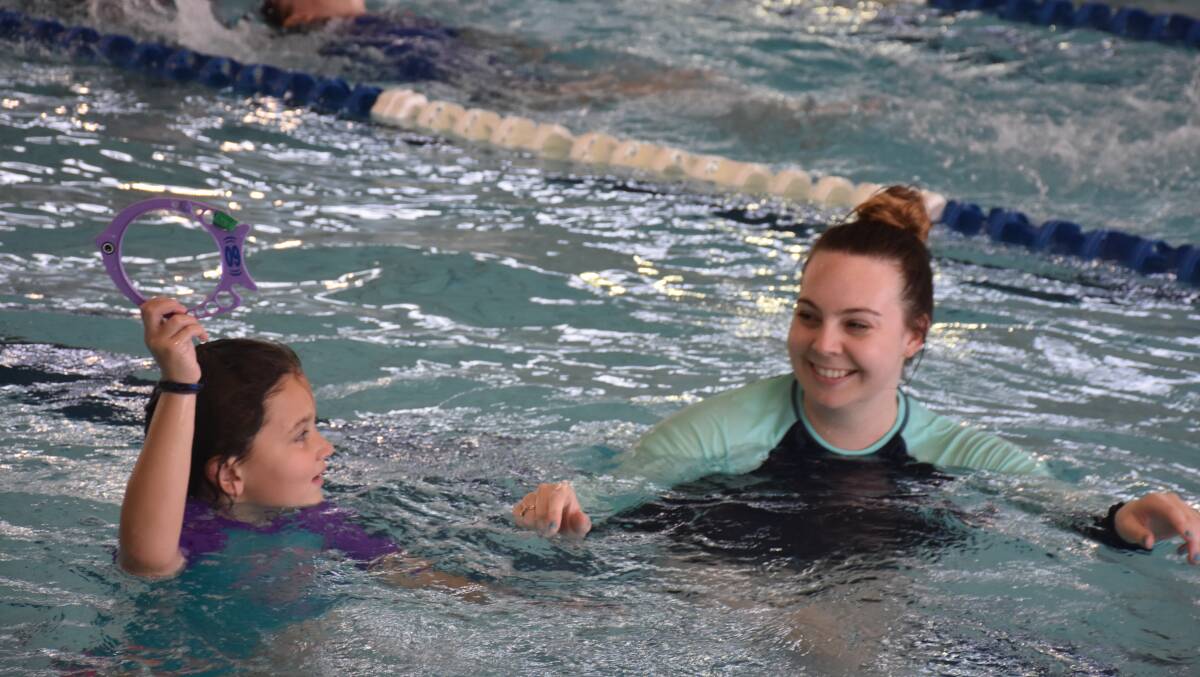 Children learning lifesaving pool skills on Wednesday afternoon.