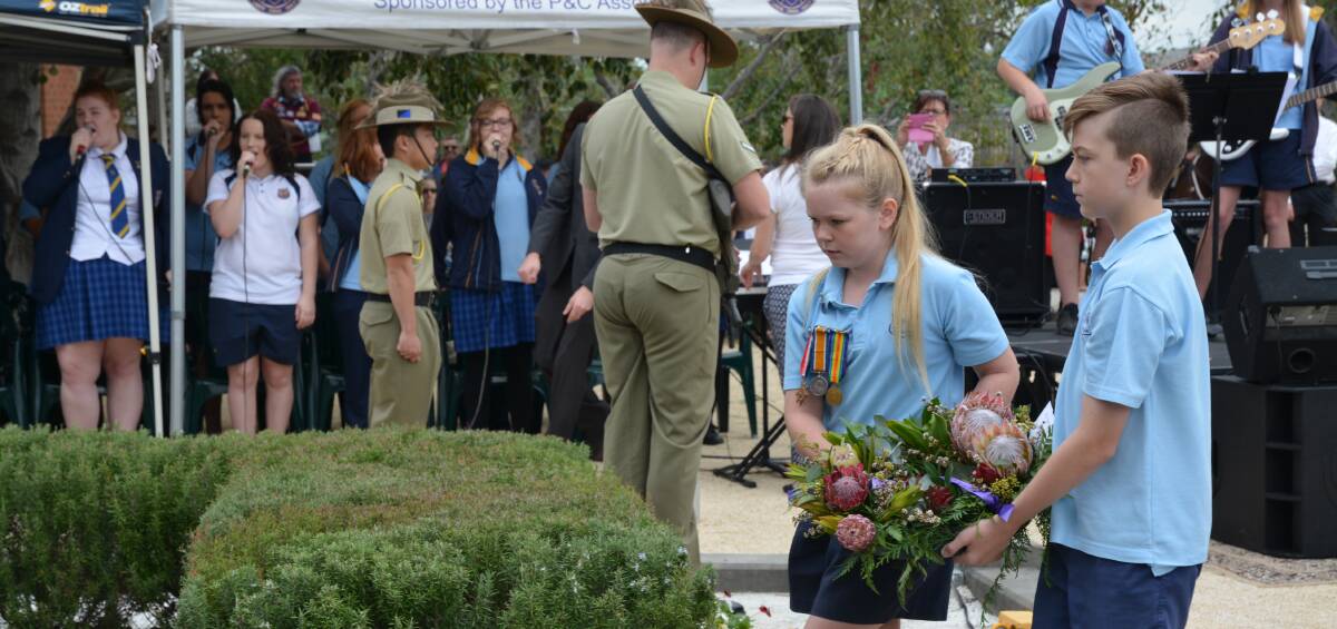 RESPECT: Muswellbrook Public School's Pollyanne Clift and Will Rankin laying a wreath at the Cenotaph. Big crowds also attended services in Aberdeen and Denman.