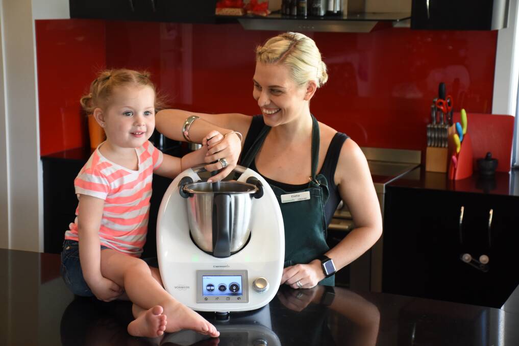 SWEET CAREER: Hazel Forder, 2, helping her mother Elisha in the kitchen with their Thermomix.