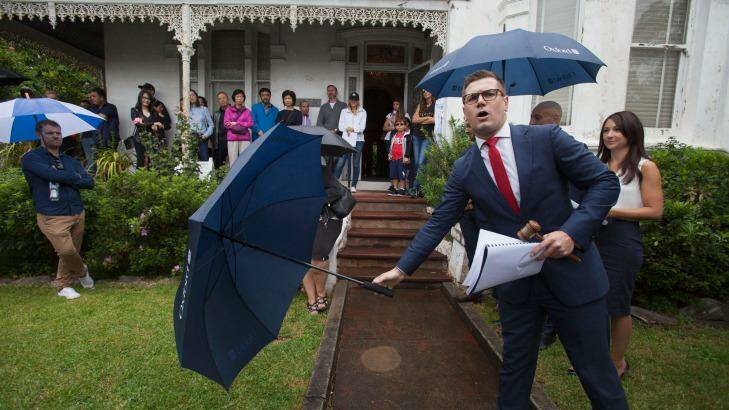 Auctioneer Jesse Davidson gets $3.87 million for a house on George Street, Marrickville, on Saturday. Photo: Fiona Morris