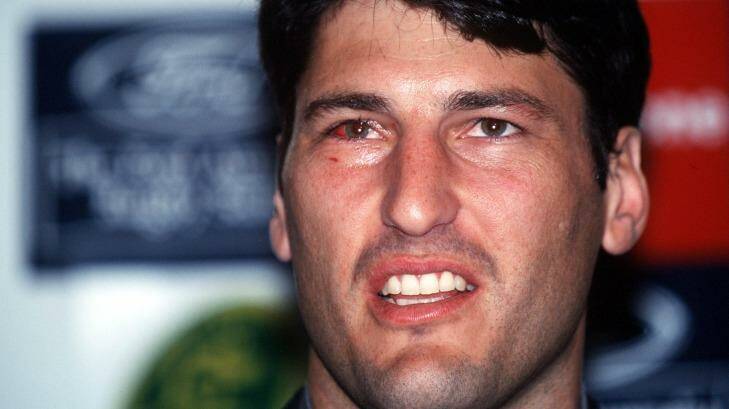 John Eales arrives back in Sydney after the Wallabies’ 1999 World Cup triumph with a badly bloodshot eye, the result of French gouging during the final. Photo: Allsport