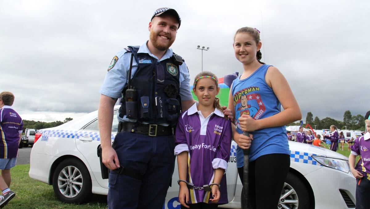 COPS ARE TOPS: The Hunter Valley Local Area Command were represented, with constable Benjaman Sherman showing kids they can talk to the police, while Imogen Owen, 9, and Nardia Owen, 11, get a taste of what policing is like.