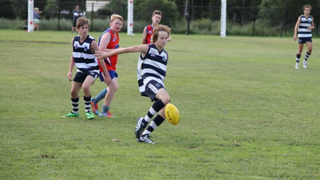  GREAT STUFF:  Josh Page kicking up field in the Cats’ second match of the season played at Warners Bay against the Bulldogs.  The local boys are finding early form in the season in what has been a strong start.