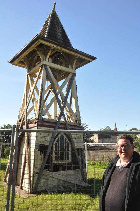 ASSISTANCE SOUGHT: Father Scott Dulley in front of the bell tower at St Alban’s Church in Muswellbrook.