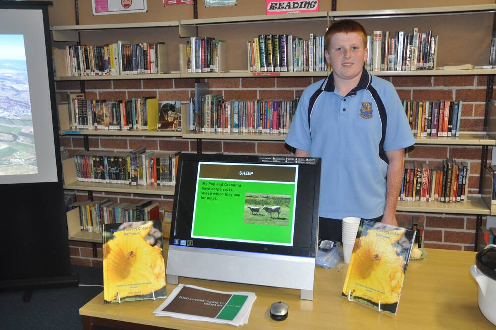 Muswellbrook High School Year 7 student, Owen Barry, with his book, The Food Lover's Guide to Yarrawa: food grown and raised at Yarrawa, Denman.