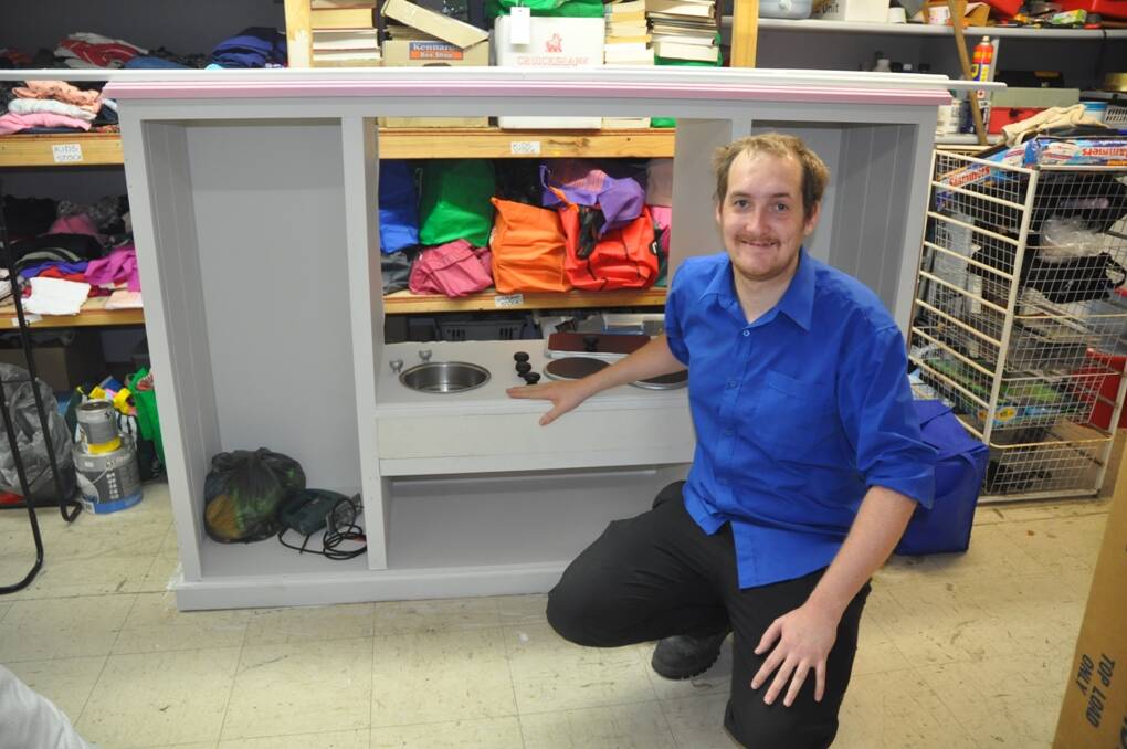 NEW LIFE: Lifeline Store assistant manager, Ben Schofield, with the latest upcycling of a television cabinet that creatively being transformed into a toy kitchen space, just one example of the upcycling now going on at Muswellbrook Lifeline.