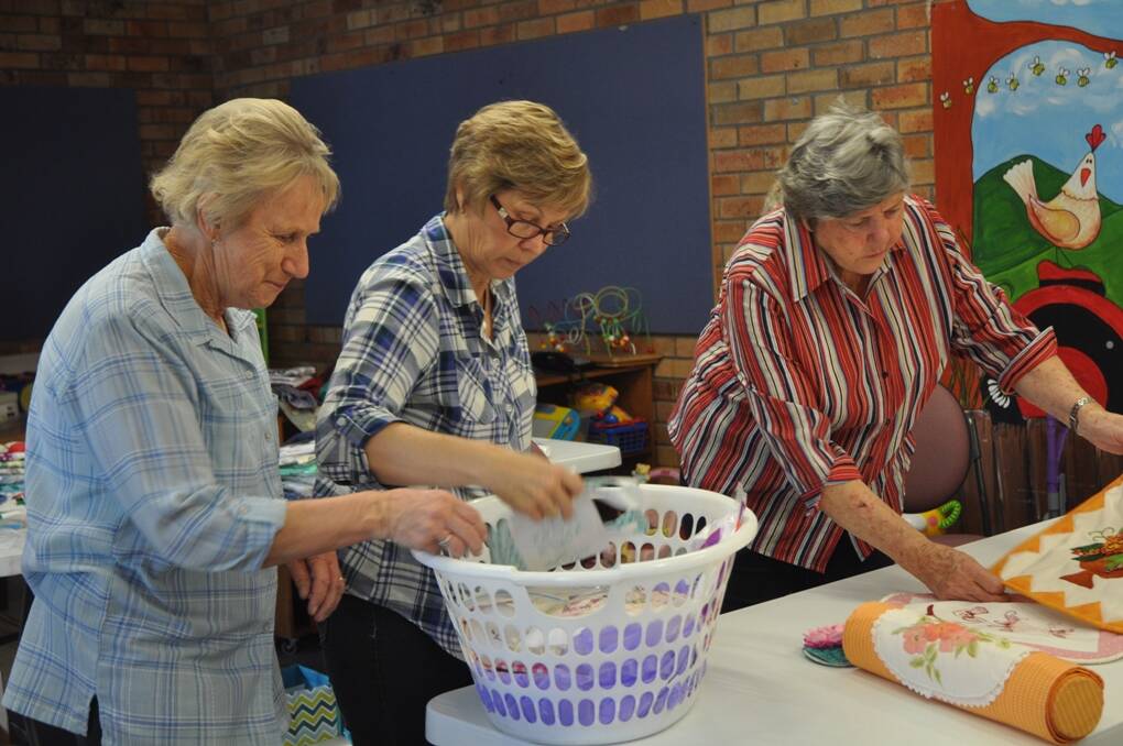 STITCH IN TIME: Embroiderers Guild members, with convenor Sheena Hooper on the far right, organising exhibits on the pricing day ahead of the exhibition.