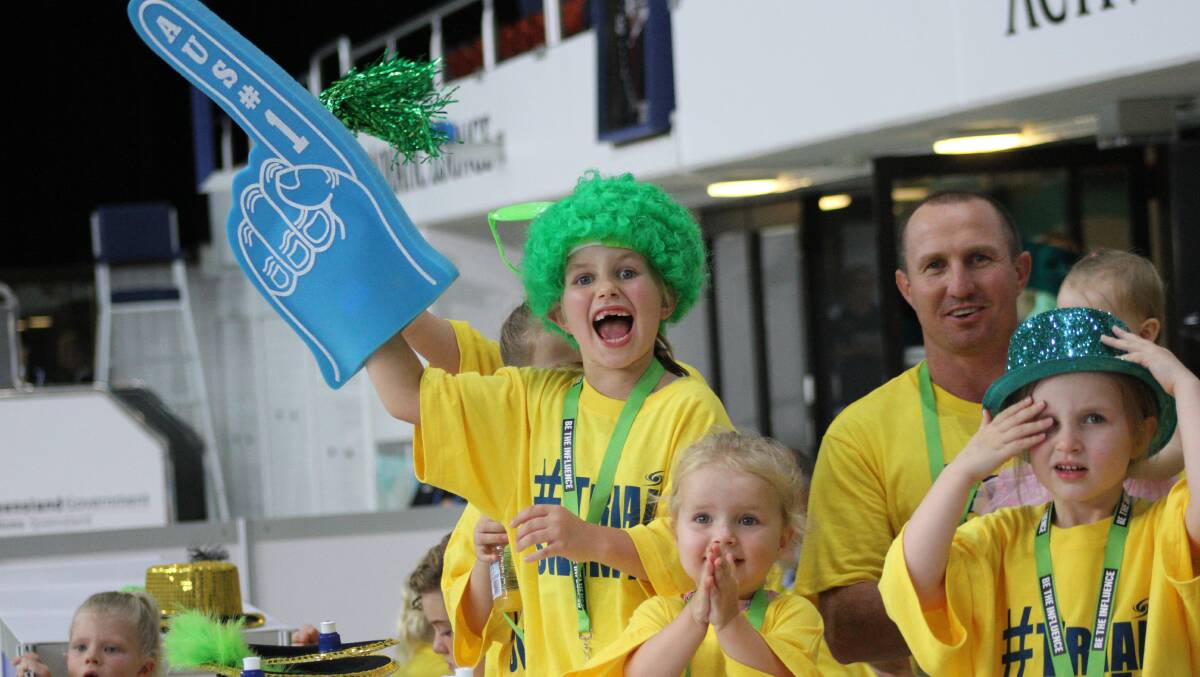 Fiona O Meara, 7 (in wig), and her family cheer on swimmers at the Australian Swimming Championships trials at Chandler. Photo: Chris McCormack