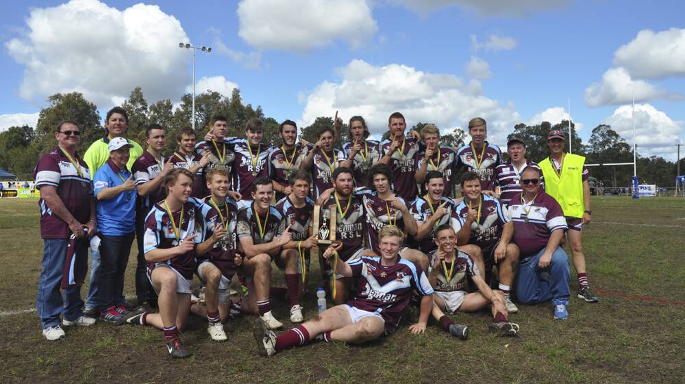 WE ARE THE CHAMPIONS: The Denman Devils under-18 squad and coaching staff celebrate Sunday’s triumph over the Muswellbrook Rams.