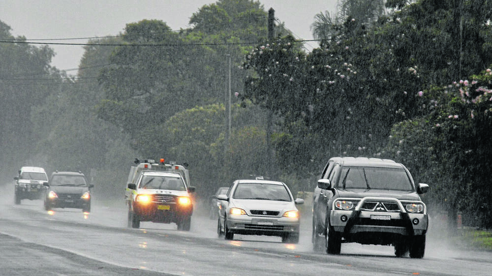 WET: Drivers with lights on at 2.30pm making their way along a very wet Sydney Street in Muswellbrook on Tuesday afternoon as the rain fell.