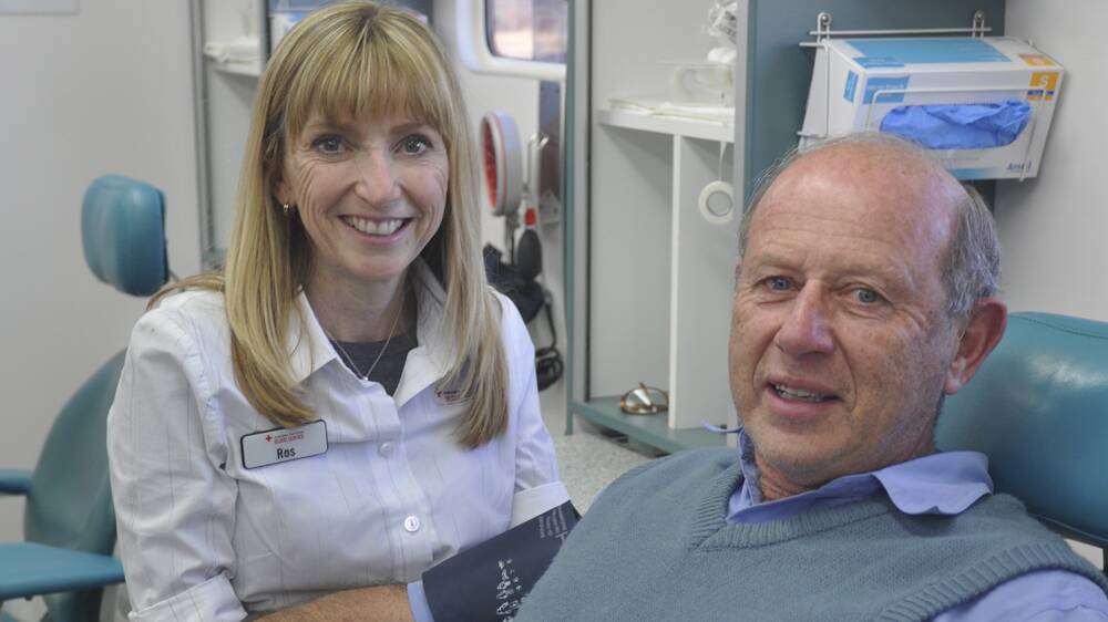 
RED-DY TO HELP: Australian Red Cross Blood Service’s Ros Armstrong and regular blood donor George Smith at the Donormobile in Muswellbrook.
