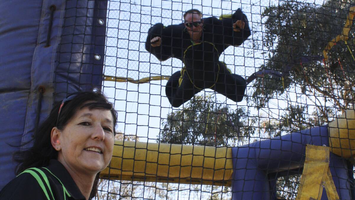 FLYING WITHOUT WINGS: Lake Liddell Recreation Area manager Julie Elphinstone watches husband Ged in the windtunnel, one of the latest attractions on site.

