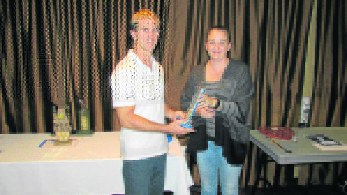 DEDICATED: Kellie Cutrupi presents Peter Howard with an award for giving the most assistance this season at the Muswellbrook Amateur Athletics Club’s presentation.