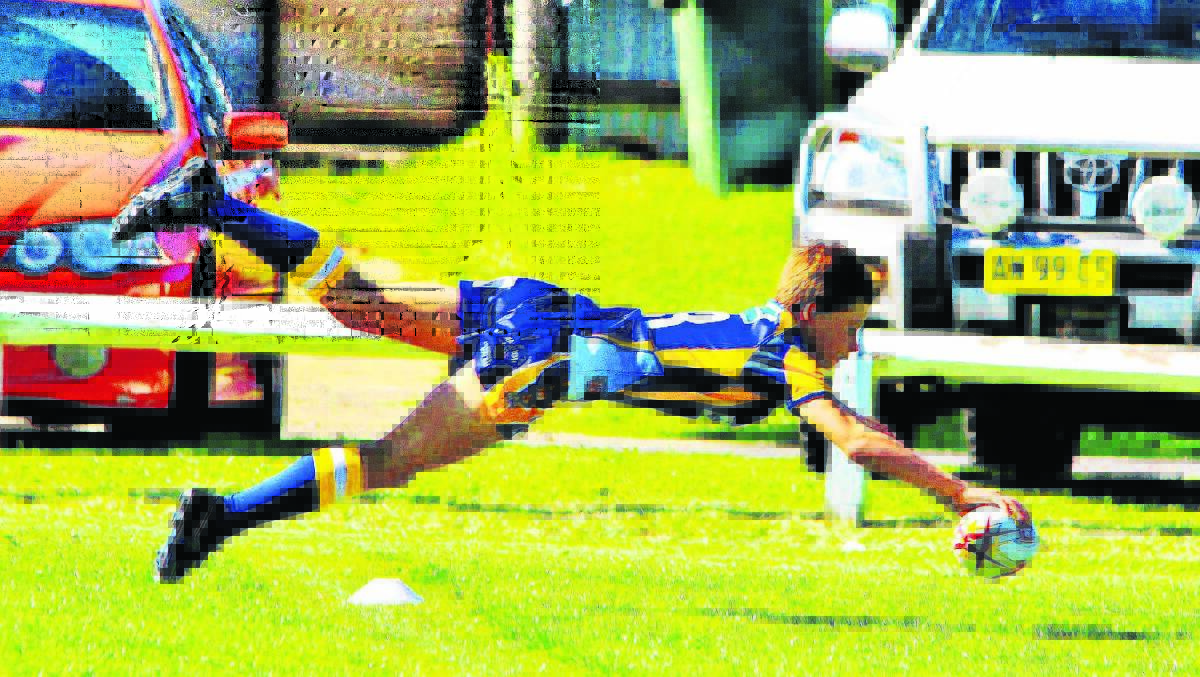SPECTACULAR: Muswellbrook Rams under-11 player Brody Perry scores a try.