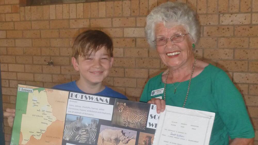 WELL DONE: Year 6 student from St James’ Primary School, Scott Wilson, was congratulated by Muswellbrook CWA international officer Neita Burkill on the success of his Botswana poster.