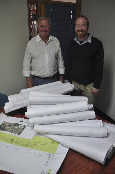 HEAVY WORKLOAD:  Newly reinstated Deputy Mayor Malcolm Ogg (left) and Mayor Martin Rush continue their solid working relationship after being relected to their positions at Monday’s meeting of Muswellbrook Council.  They are pictured with a significant pile of council projects now being undertaken or about to start.