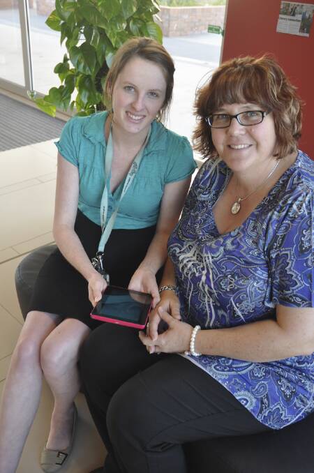 NEW CHAPTER: Muswellbrook library’s Lauren Allan shows Charmaine O'Leary tips for using the new eBook readers available for loan.
