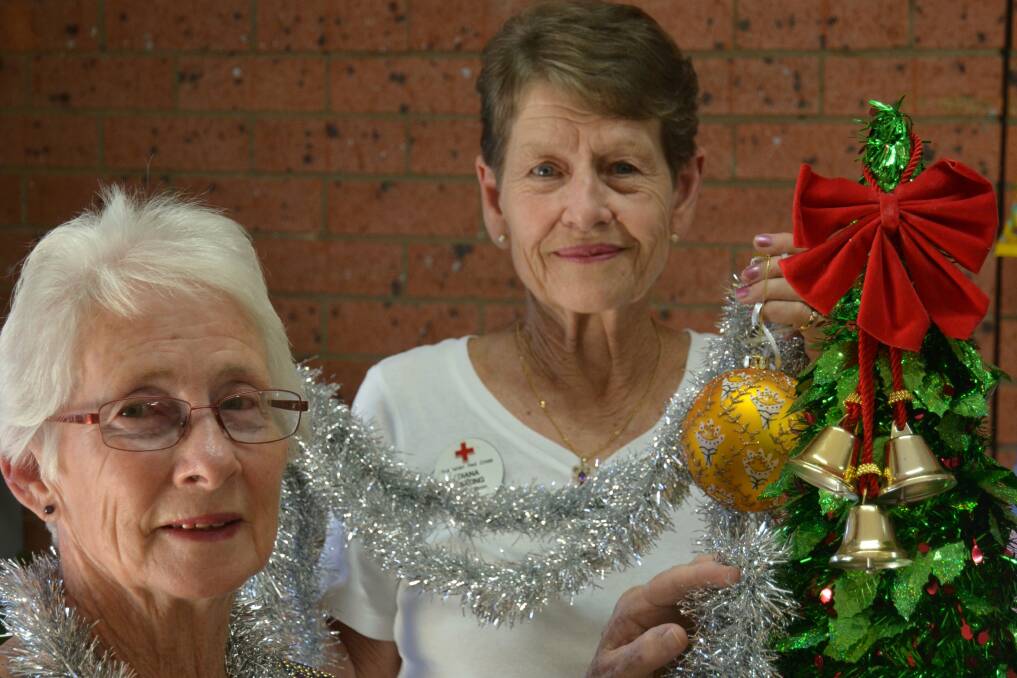 FESTIVE: Muswellbrook Red Cross president Diana Keating, and member Val Angel.