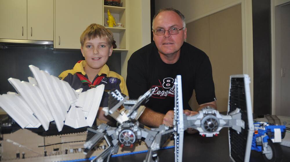 CREATIVE:  Chris Joy, 9, and his dad Phil, with some of their latest Lego creations.  The models will be among hundreds to go on display at the Scout Hall on November 2. 