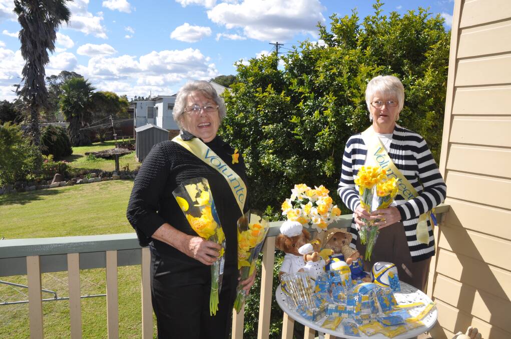 AUGUST: BRIGHTEN YOUR DAY: Volunteers Marie Wild and Libby Miles will sell  daffodils and merchandise today to raise funds for the Cancer Council.
