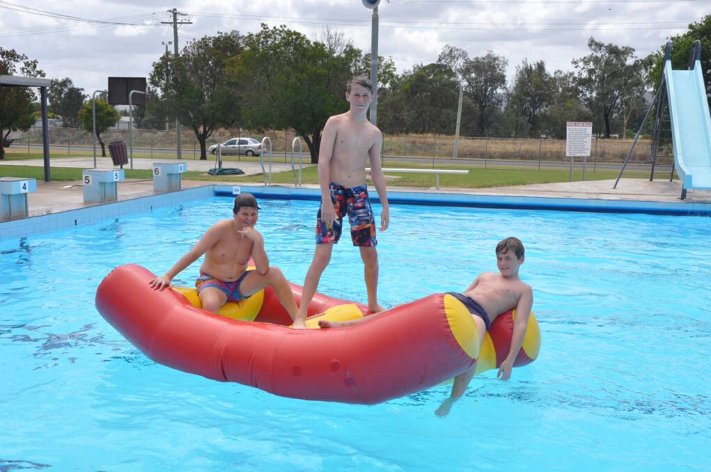 STAYING COOL: Byron Warroll, 13, Ben Wolfgang, 13, and Lachlan Barry, 12, cooled off in the pool on Australia Day.