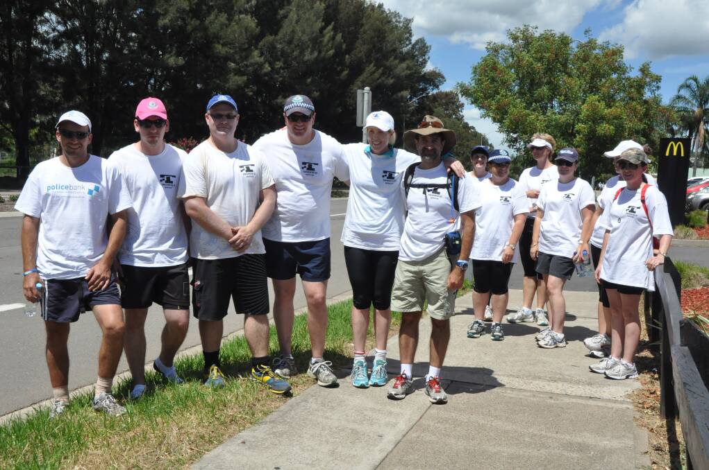 MARCH: GOING THE DISTANCE:Hunter Valley Local Area Command police officers, front from left, Dan Carter, Max Ivancevic, Mick Fleming, Chris Russel, Alex Cant and Guy Guiana took part in the entire length of the walk – and were joined by five members of the Muswellbrook station staff and another officer to walk from Muswellbrook to Aberdeen.