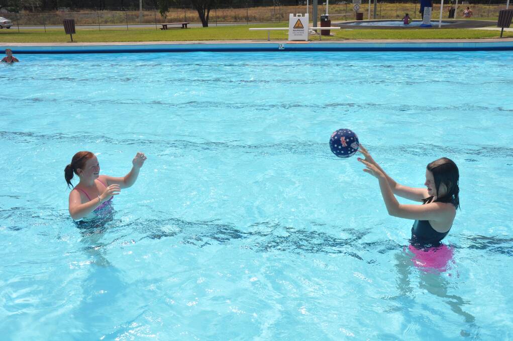 SUMMER FUN: Hailey Parker, 12, and Heidi Wolfgang, 12, made use of the free pass to Denman Aquatic Centre.