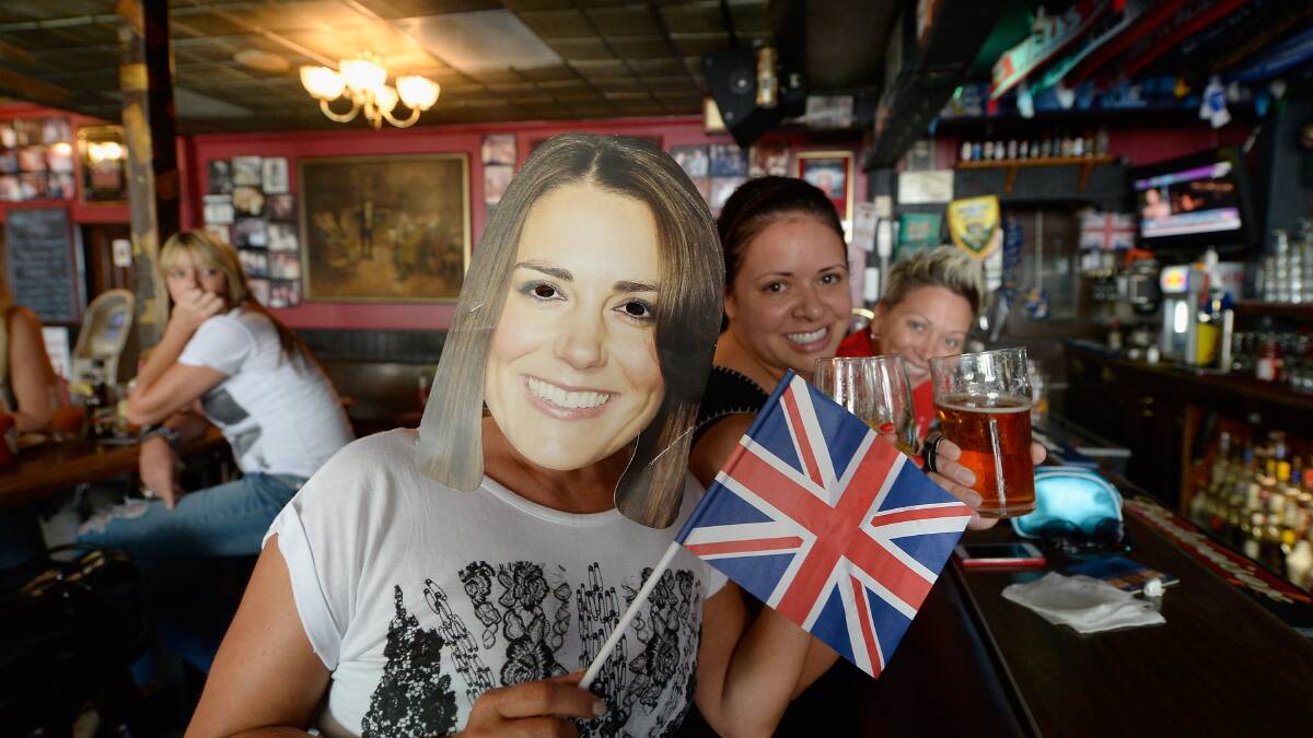 Karen Milne, (L) from Scotland, wears a mask representing Catherine, as she and her friends Rachelle Rodriguez (C) and Michelle Lewis (R) celebrate the royal birth announcement. Picture: Getty