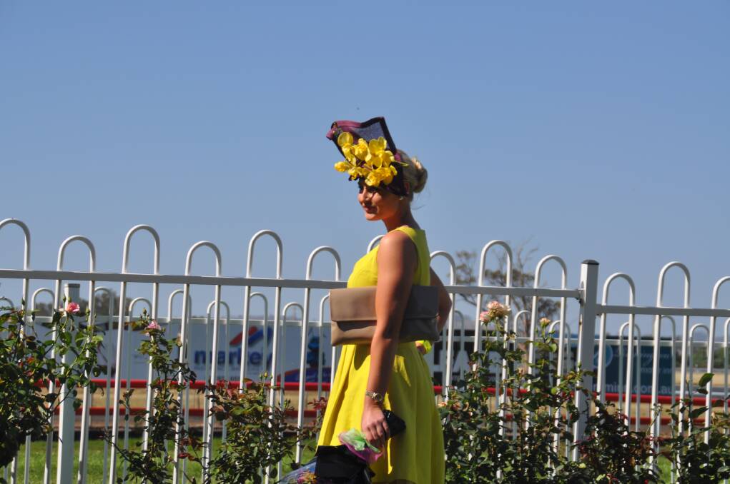 RAY OF SUNSHINE: Striking in yellow, Fashions on the Field winner Amy Clunes, from Darley.