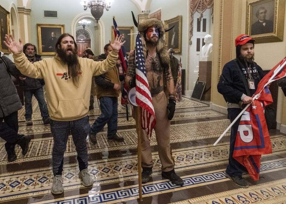 Jacob Anthony Chansley, centre, an Arizona man, was one of those arrested for the storming of the US Capitol building in Washington. Picture: AP