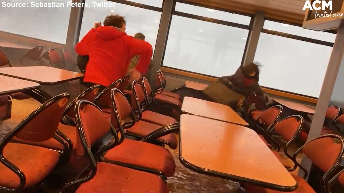 Others grabbed their belongings and ran to the back of the ferry as river water spread all across the floor. Photo: Sebastian Peters, Twitter.