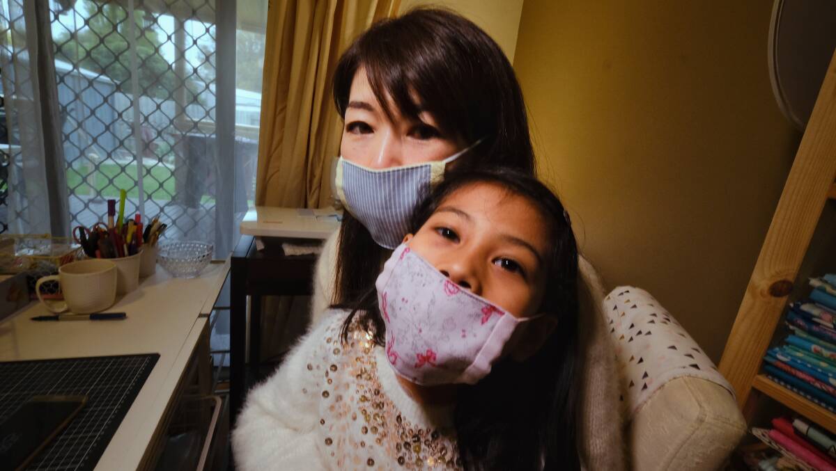 Sayaka Nakamoto with daughter Mira, 5, wearing their face masks at their home in Altona. Photo: Luis Enrique Ascui.