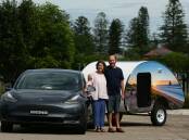 Electric Dreams: Ian and Heidi Wilcox with their Tesla towing a caravan. They're heading north for the weekend. Pictures: Jonathan Carroll   