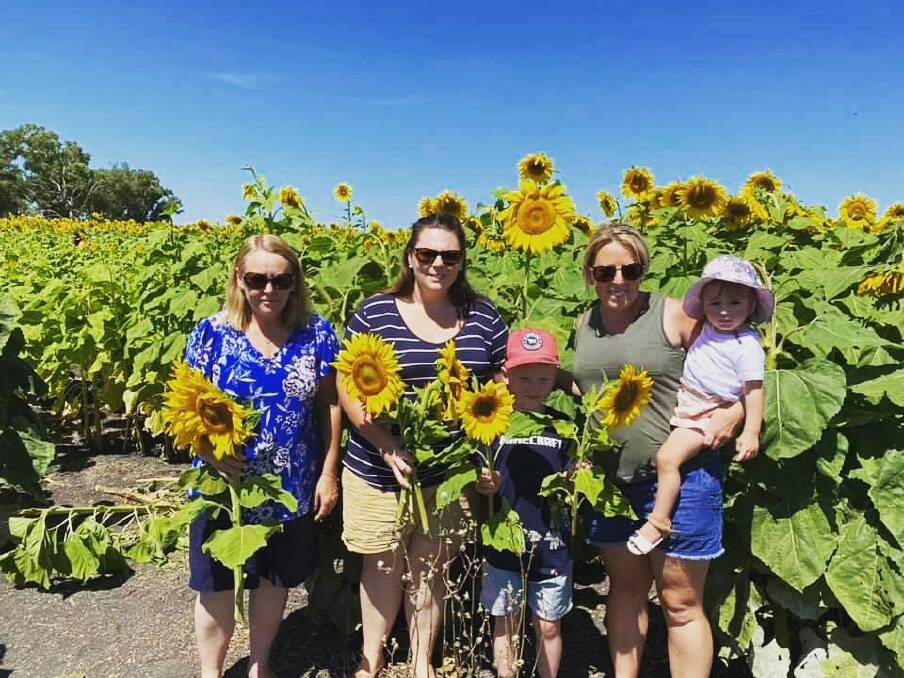 Upper Hunter residents Kim and her daughter Kate, her grandson Bailey, daughter Samantha and her grand daughter Olivia visited the Carter family property near Quirindi recently to enjoy the sunflowers.
