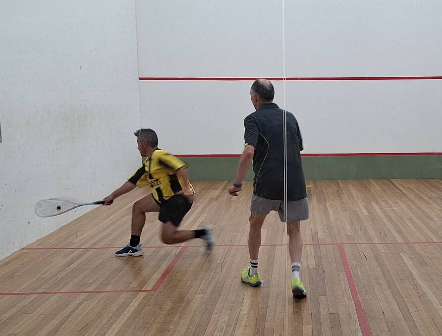 Sebastian Angelillo in crouch mode to get the backhand shot against a watchful Mark Rikard-Bell. Picture supplied