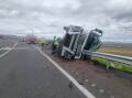 The driver had a lucky escape after this B-double truck rolled on the Golden Highway. Picture by Fire and Rescue Denman