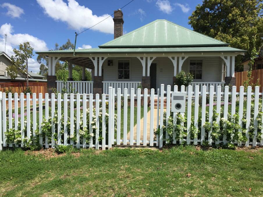 AFTER: When buying a fence, choose a style in keeping with your home. Go for subtle tones of flowers for your garden if planting against a plain white backdrop. Match the letterbox with the fencing and keep it clear of promotional pamphlets.