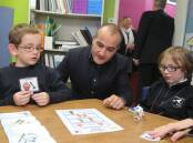 Minister for Education James Merlino, pictured during a past school visit to the south-west, announced a plan to keep education settings open while taking measures to protect students and staff. 