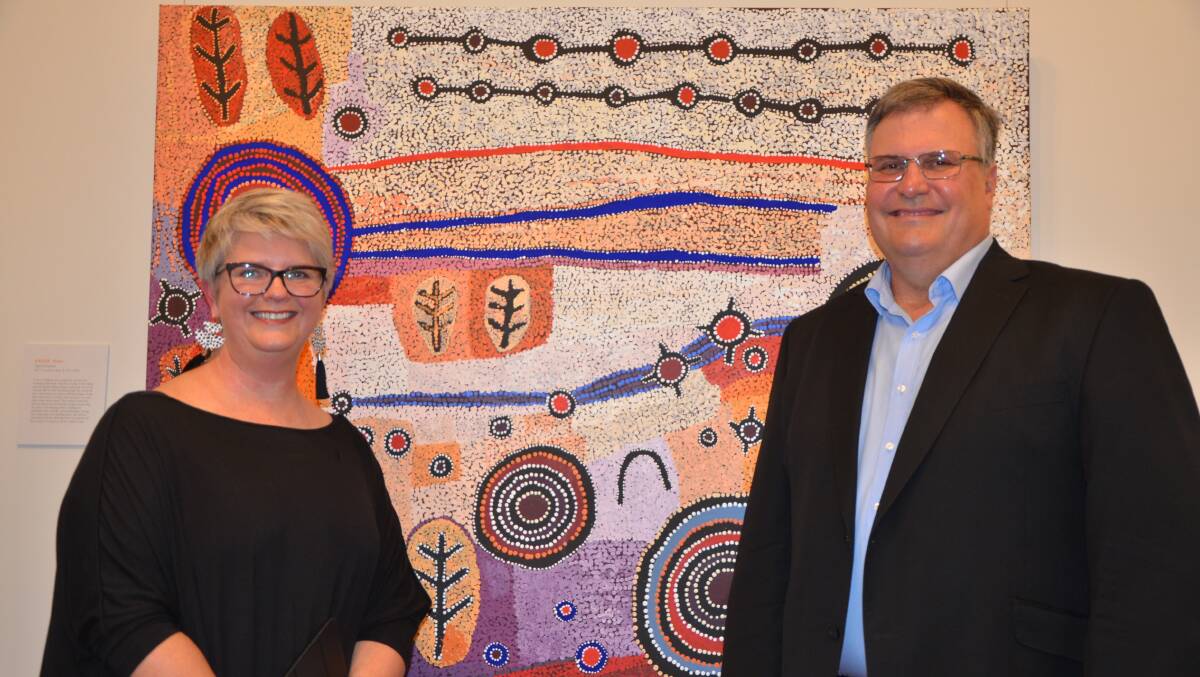 IMPRESSED: Adjudicator Tracy Cooper-Lavery and Bengalla Mining Company CEO Cam Halfpenny with the winning painting, ‘Ngura (Country), at the Muswellbrook Regional Arts Centre.