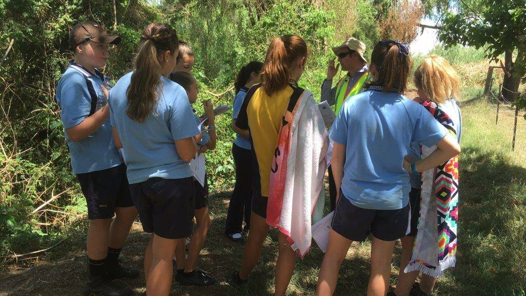 HANDS ON LEARNING: Sustainability Officer Mick Brady with students from Muswellbrook High School. 