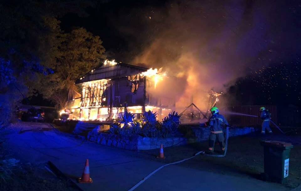 DESTROYED: Firefighters attempt to put out the Shaw Crescent house fire on Tuesday night. Pic: FIRE AND RESCUE NSW 392 MUSWELLBROOK 