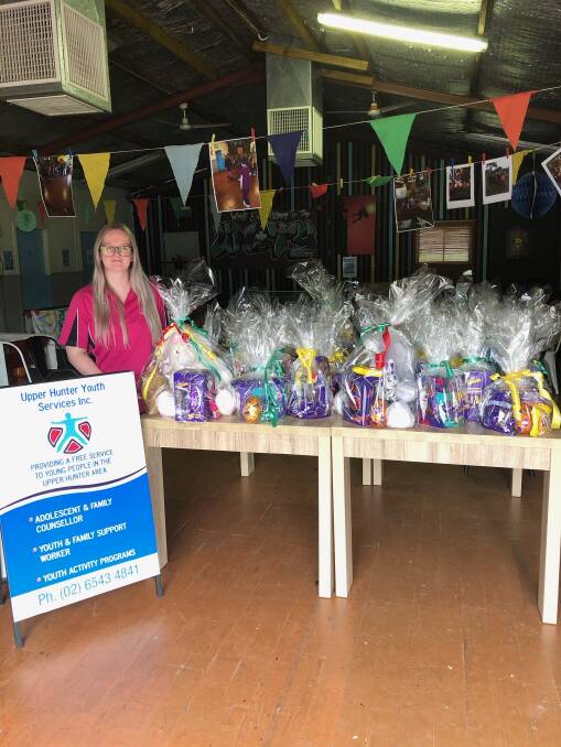 YUMMY: Upper Hunter Youth Services Inc's youth worker Makaylah Angel with the Easter gift packs, which were donated by the Muswellbrook RSL Club.